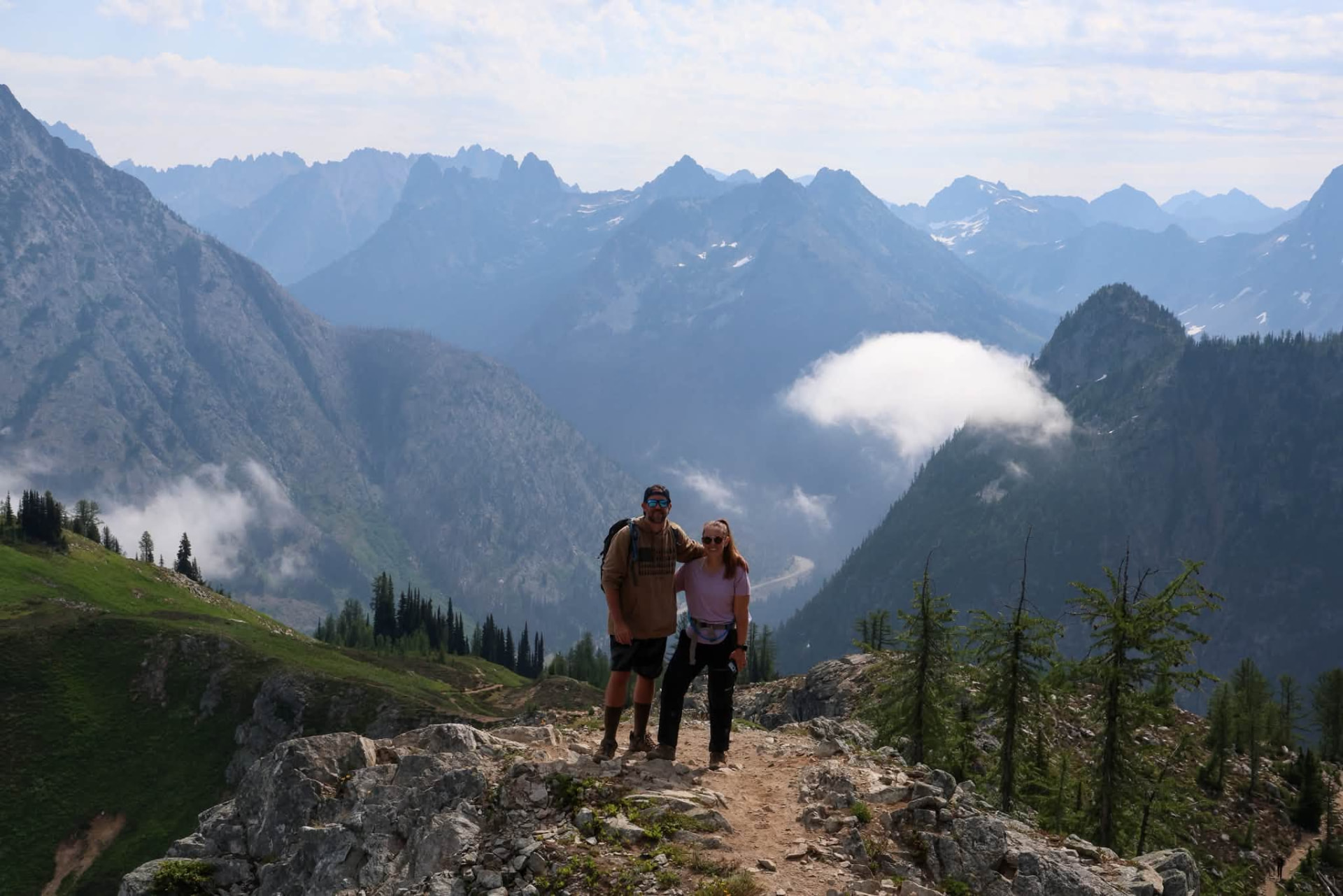 Doug and Brittany standing together on a mountain ridge