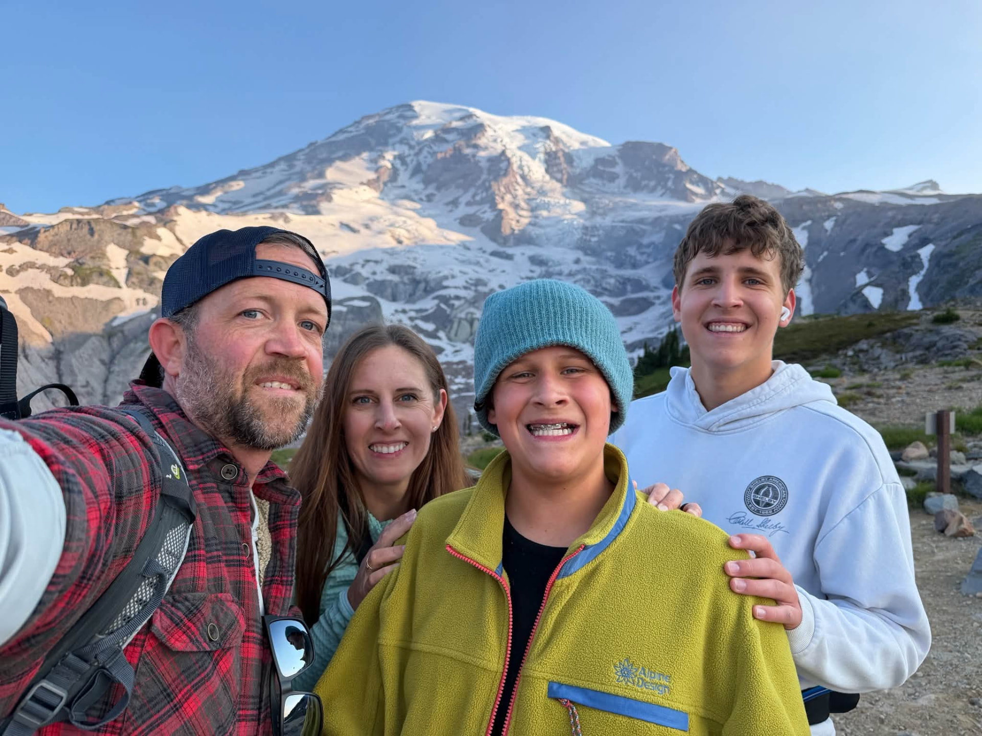 Douglas Vaughan with his family on a ridge below Mount Rainier at sunrise